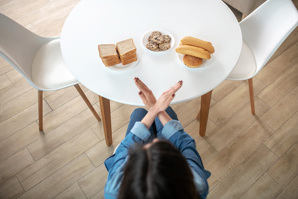 No carbs. A woman refusing to eat bread, buns and cookies