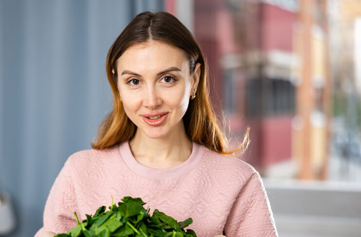 El magnesio como mineral esencial para nuestro organismo Smiling girl eating green salad at home